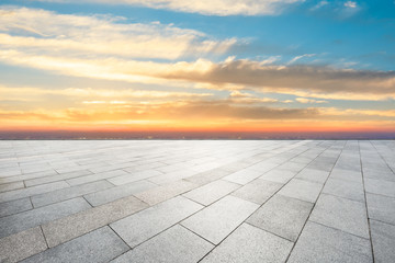 Fototapeta premium Empty square floor and modern city skyline with beautiful colorful clouds at sunset