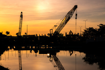 Obraz premium A crane car in the construction site reflect in the swamp