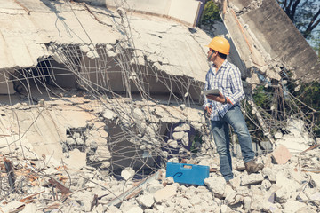 Engineer architect and worker operation control demolish old building.