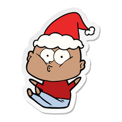 sticker cartoon of a bald man staring wearing santa hat