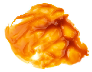 Sweet caramel sauce drop isolated on white background close up. Golden Butterscotch toffee caramel...