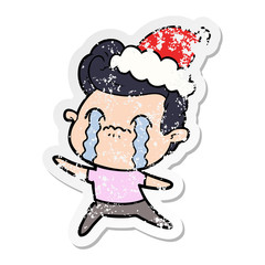 Fototapeta premium distressed sticker cartoon of a man crying wearing santa hat