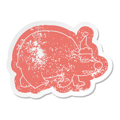 cartoon distressed sticker of a angry polar bear wearing santa hat