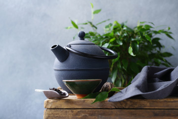 cast iron kettle on wooden table for tea ceremony