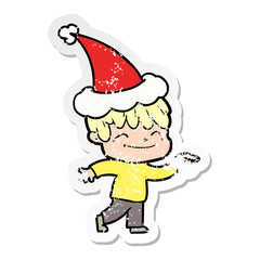distressed sticker cartoon of a happy boy wearing santa hat