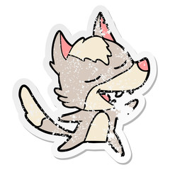 distressed sticker of a cartoon wolf laughing
