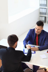 Business people shaking hands after good deal