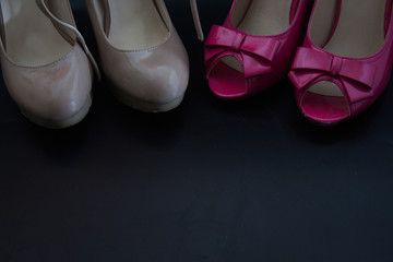 Two high-heels, nude and pink heels, shooes for women, black backgraund