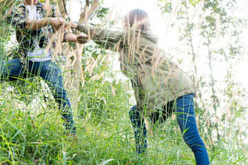 man and woman walk in the forest