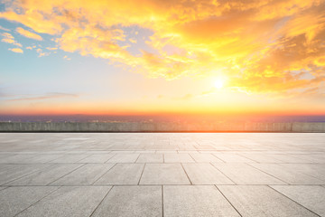 Empty square floor and modern city skyline with beautiful colorful clouds at sunset