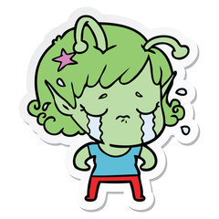 sticker of a cartoon crying alien girl