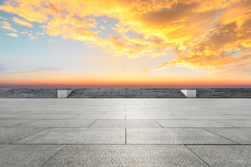 Empty square floor and modern city skyline with beautiful colorful clouds at sunset