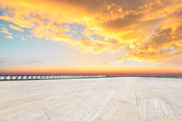 Empty square floor and modern city skyline with beautiful colorful clouds at sunset