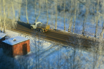 water truck driving along the road in the middle of winter