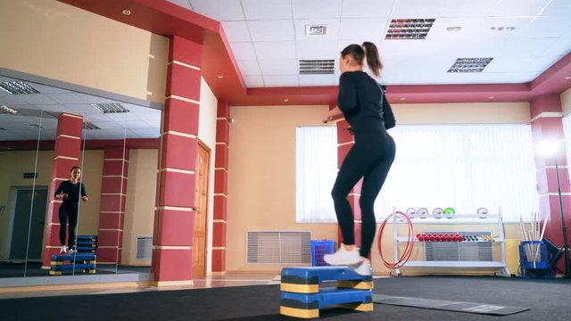 Cardio training. Young sporty woman exercising in the gym.