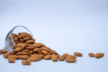 almonds on glass with white background, Indian almonds in white background