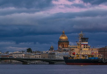 Sunset in Saint Petersburg over the Neva river with the view of the Blagoveshchenskiy Bridge and the Saint Isaac's Cathedral