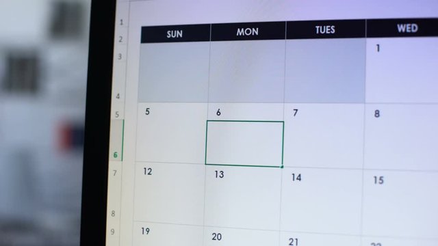 Deadline scheduled in calendar, hand pointing at pc screen, time-management