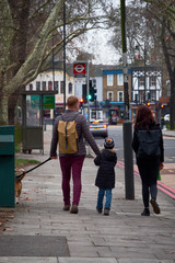 Happy style family walking along English street