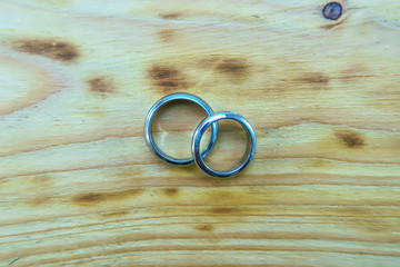 Silver ring on a wooden background.