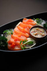 Salmon spicy On a black plate. Salmon spicy On a black background