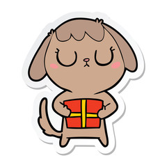sticker of a cute cartoon dog with christmas present