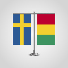 Table stand with flags of Sweden and Guinea.Two flag. Flag pole. Symbolizing the cooperation between the two countries. Table flags