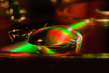light and water droplets on cd plate