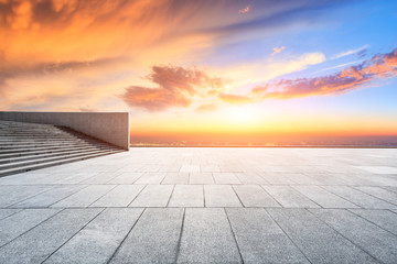 Empty square floor and modern city skyline with beautiful colorful clouds at sunset