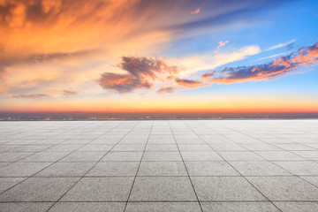 Empty square floor and modern city skyline with beautiful colorful clouds at sunset