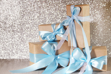 Wrapped gifts at silver background	