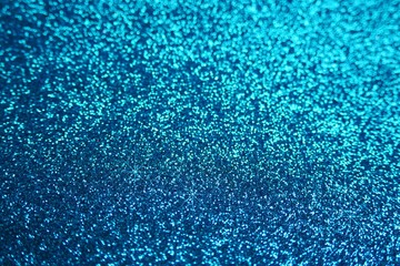 Glitter shiny wallpaper.  Glitter blue iridescent macro background with stars. Shiny backdrop.Snowy...