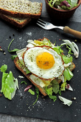 Toast with fried egg and salad. Keto breakfast or snack.