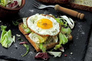 Toast with fried egg and salad. Keto breakfast or snack.