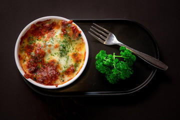spinach with cheese On a black plate.spinach with cheese On a black plate. Baked Spinach with Cheese 