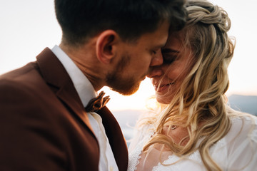 A passionate kiss of a couple in love while traveling through the mountains.