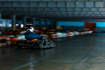 Dynamic karting competition at speed with blurry motion on an equipped racecourse