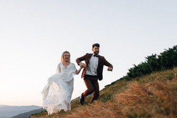 Romantic wedding trip of spouses in love in the mountains.