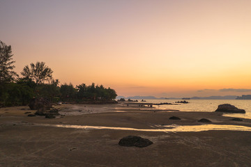 Tup Kaek beach close to Kwang beach and non Nak mountain during low tide .can see long and large beach can walk around many big rocks on the beach .beautiful sunset behind archipelago in Andaman sea