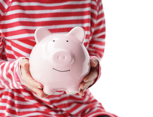 Woman with piggy bank on white background, closeup. Concept of savings