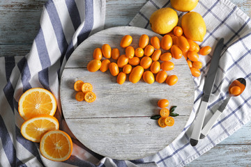 Composition with delicious citrus fruits on wooden background