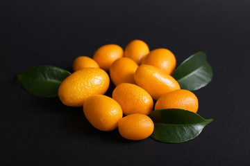 Delicious kumquat fruit on dark background