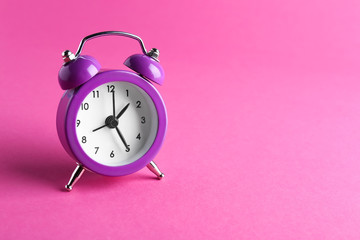 Alarm clock on color background