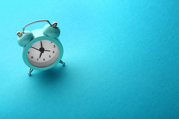 Alarm clock on color background