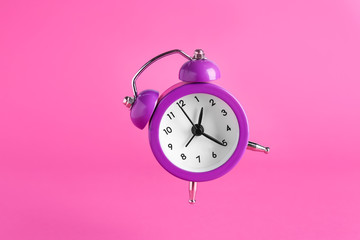 Alarm clock on color background