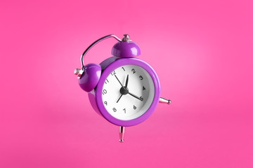 Alarm clock on color background