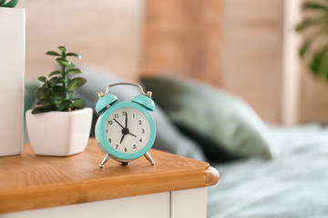 Alarm clock on table in bedroom