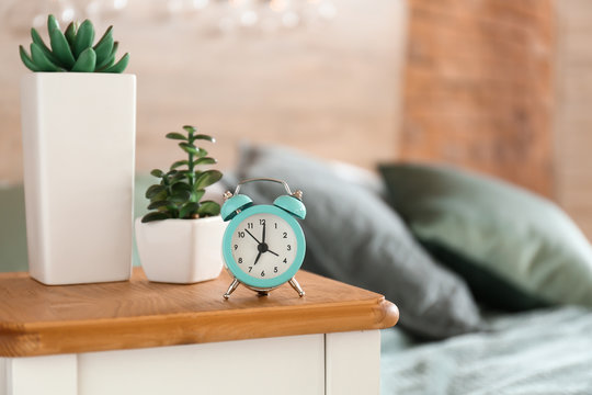 Alarm clock on table in bedroom