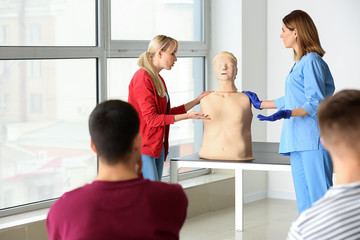 Group of people with instructor at first aid training course