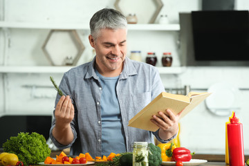 Mature man cooking dinner at home